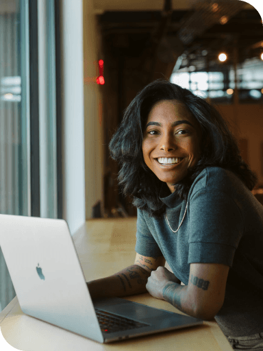 person smiling at laptop working on WP Engine Headless WordPress team