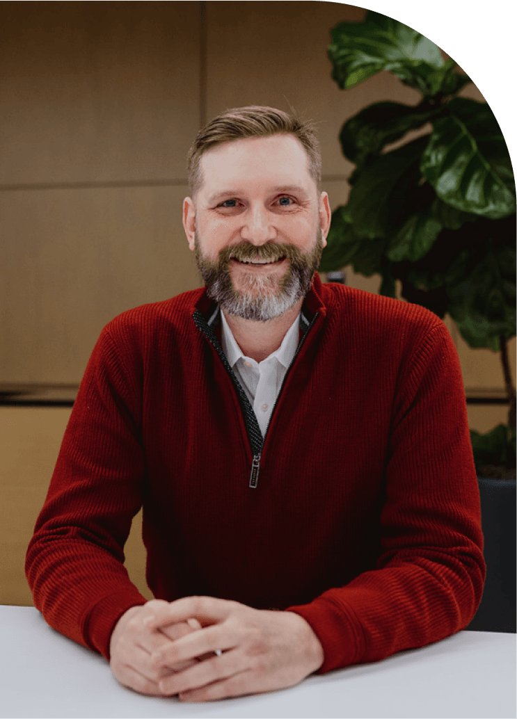man smiling with hands clasped